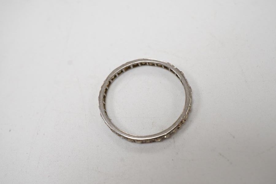 A white metal and diamond chip set full eternity ring, size O.